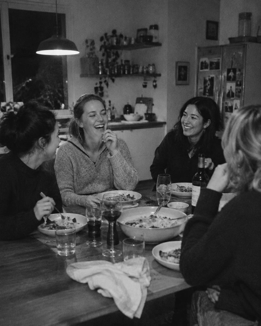 Friends sharing dinner around a kitchen table