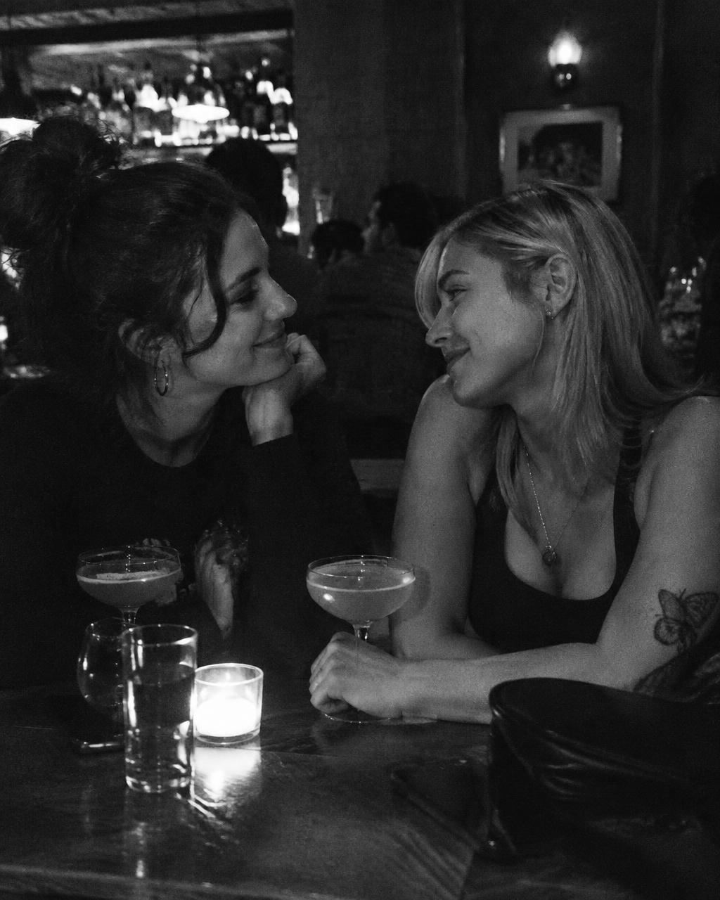 Two women on a date at a candlelit bar